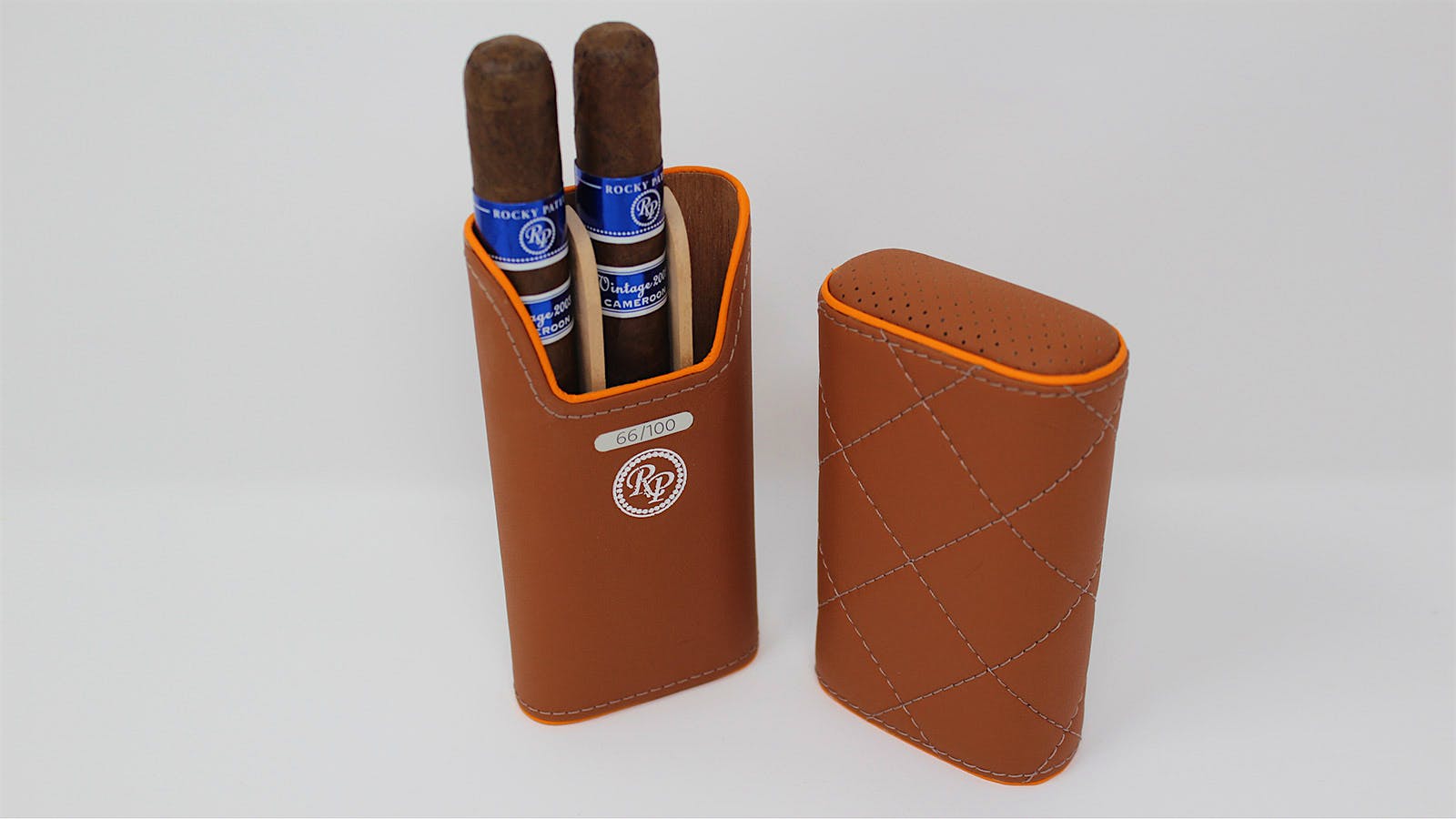 One of two Rocky Patel cases features quilted leather with diamond-shaped stitching and orange piping accents.