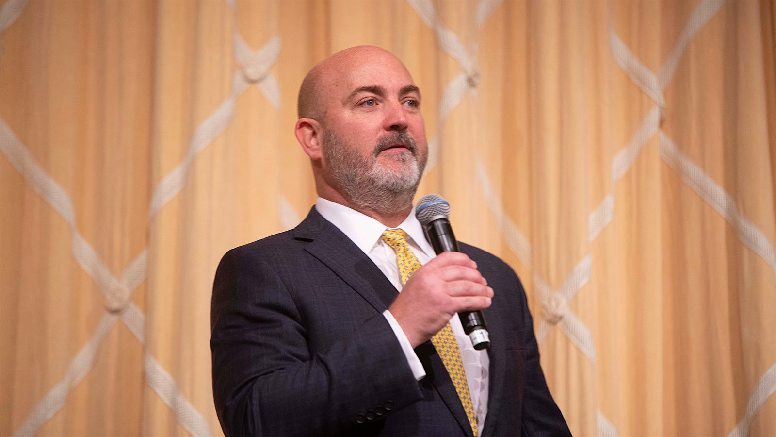 Steven Henrickson addresses the audience on behalf of company owner Al Micallef.