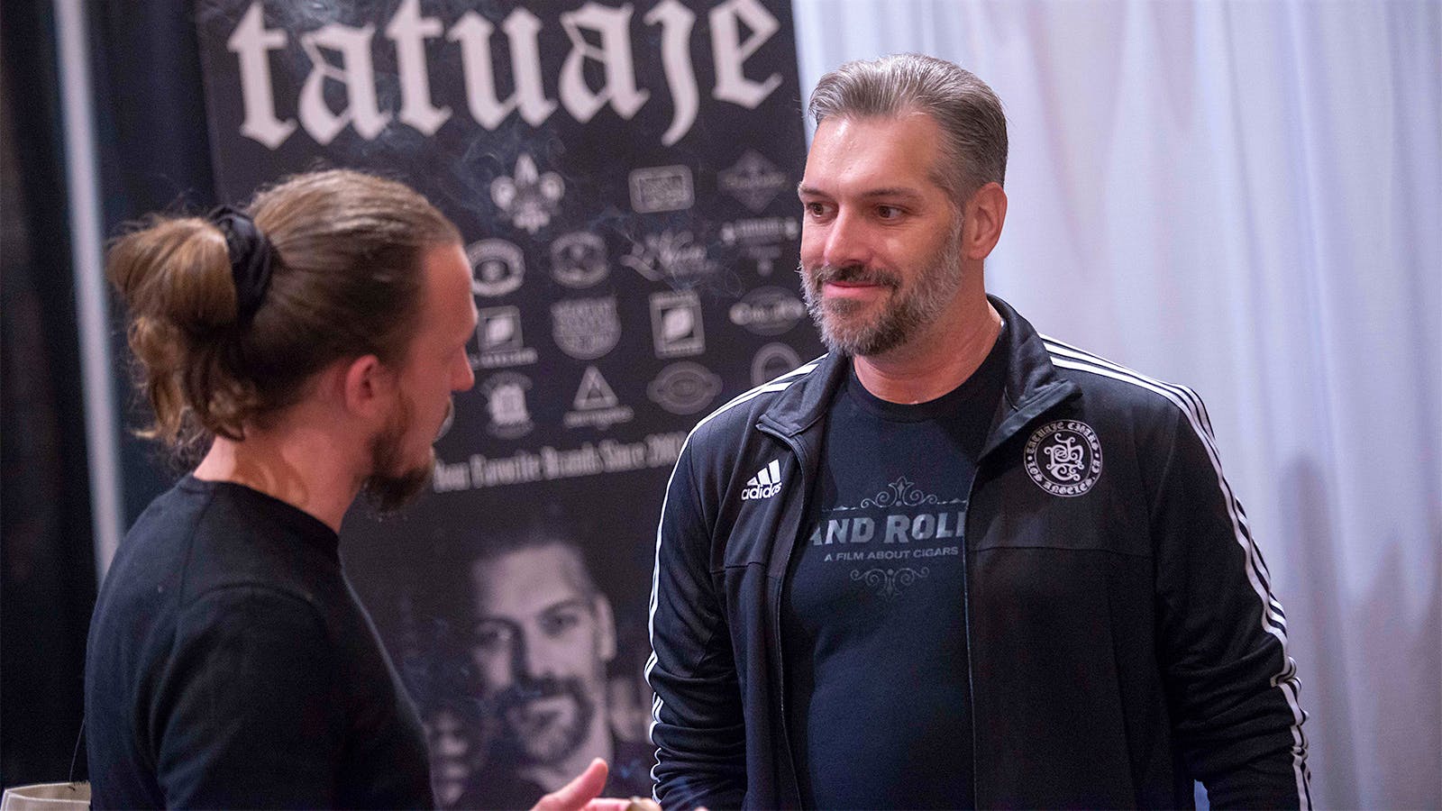 Pete Johnson of Tatuaje speaks with a fan at his booth.