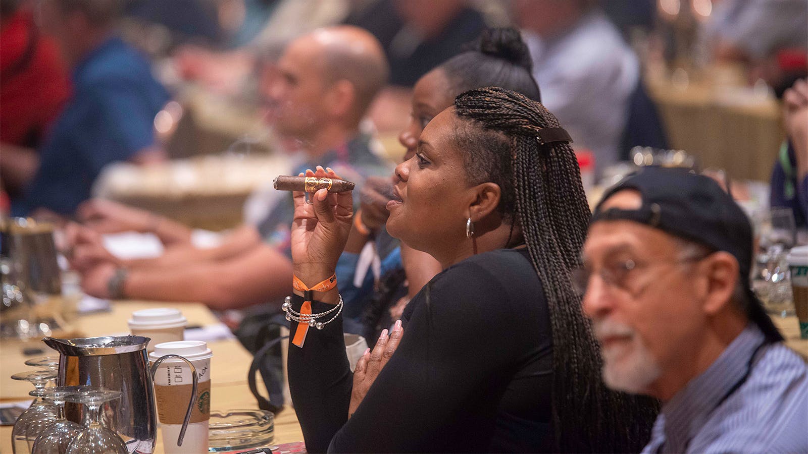 A guest puffs on an Oliva Serie V Belicoso, the No. 3 cigar of 2017, while listening to Fred Vandermarliere from J. Cortès Cigars, Oliva's parent company, talk about the cigar.