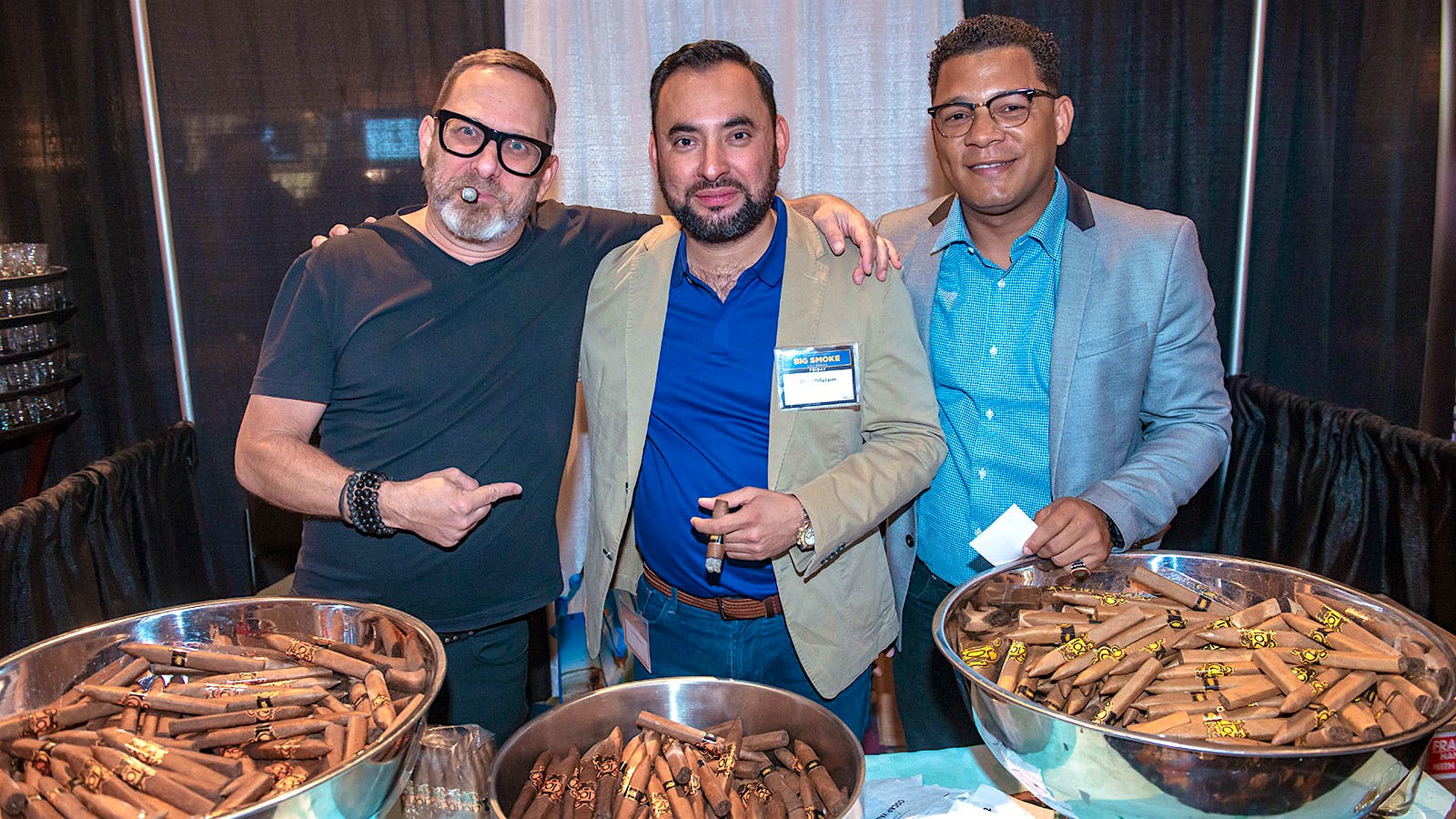 Oscar Valladares, center, and his team ready to give out a bunch of cigars to the Big Smoke crowd.